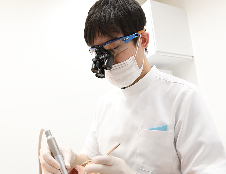 公式トップに掲載された拡大鏡を用いる院長の診療場面
