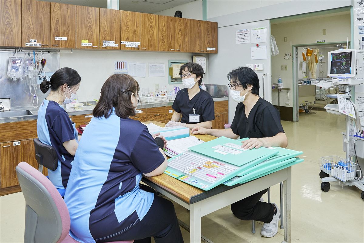 公式看護部紹介に掲載される、病棟で情報共有を行う看護スタッフ