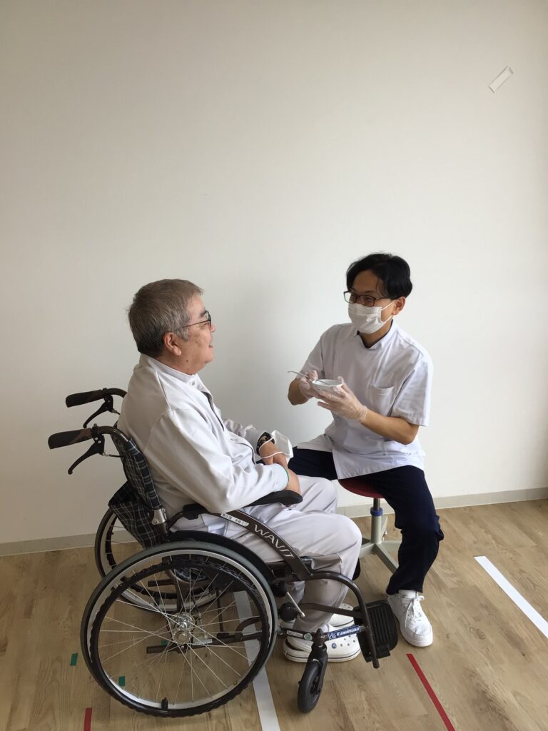 療法士と利用者がカードを使った訓練を行う様子