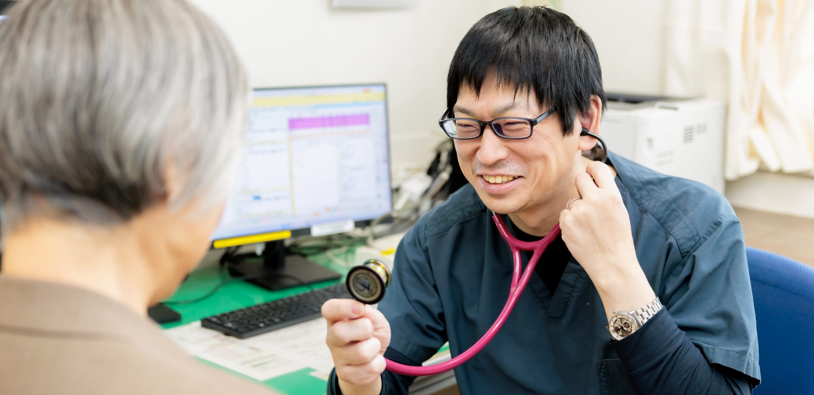 公式トップに掲載される、医師が患者を診察する様子
