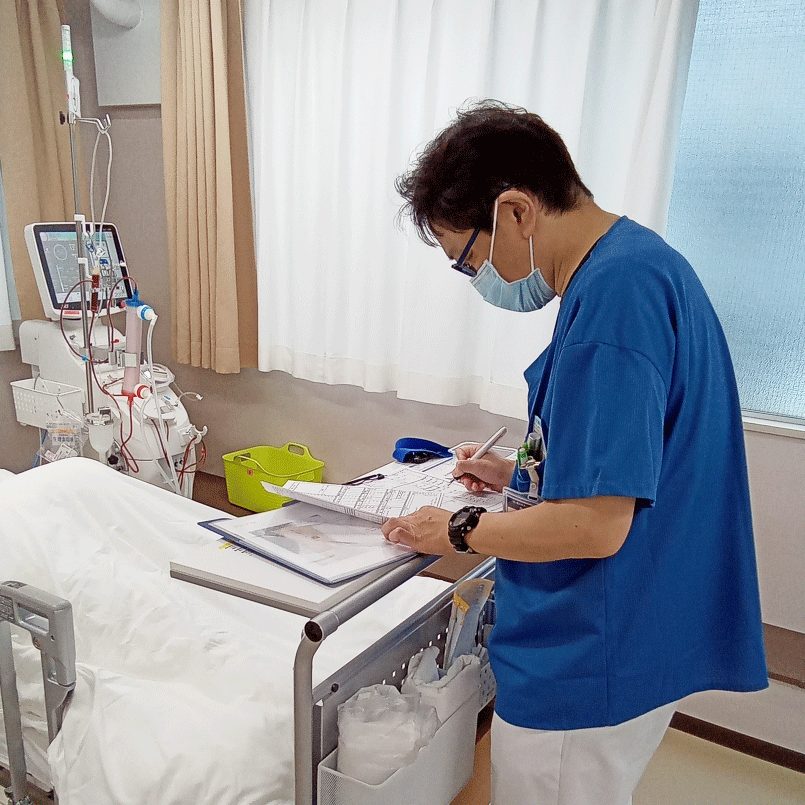 透析病床で患者をケアするスタッフ