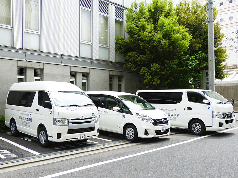 法人名表示のある送迎車